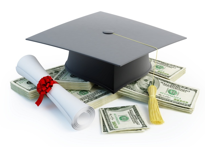 Graduation cap, diploma, and cash for Grand Trust tuition assistance loans